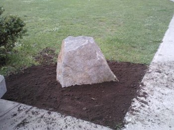 Mike Halas of Halas Farm Market donated and delivered the rock that will be used to mount the Veterans Walkway of Honor plaque to marking the beginning of the walkway.